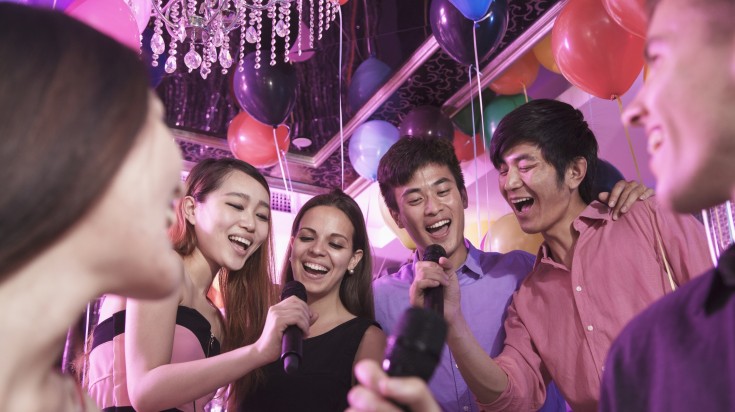 Group of friends singing karaoke