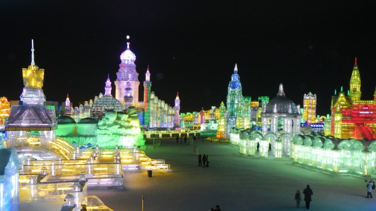 Swing saws taken from the frozen surface of the Songhua River are used to carve ice into blocks Tourists amidst the illuminated ice towers at the Harbin Ice Festival
