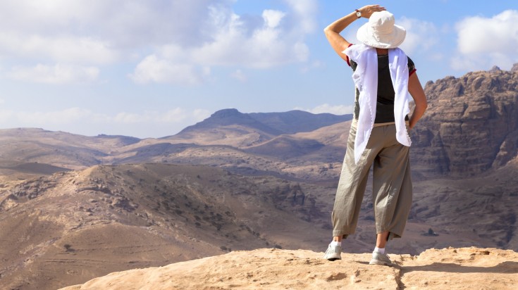 A hiker enjoying the view of Jordan's desert.