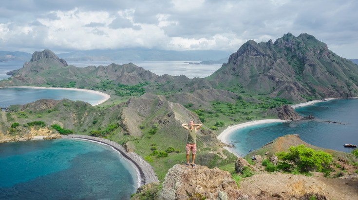 A hiker posing in Komodo National Park on a cloudy day.