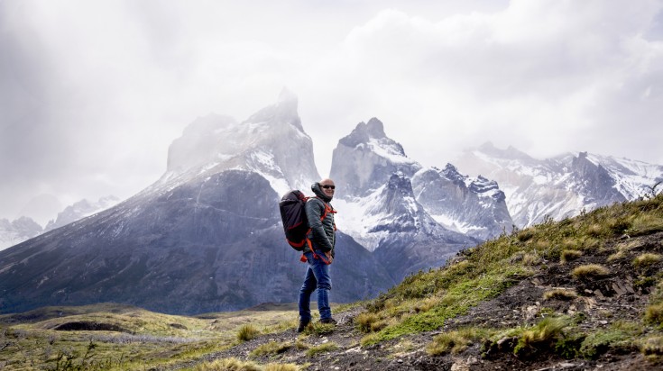 A tourist man happy during his hiking trip to Patagonia.