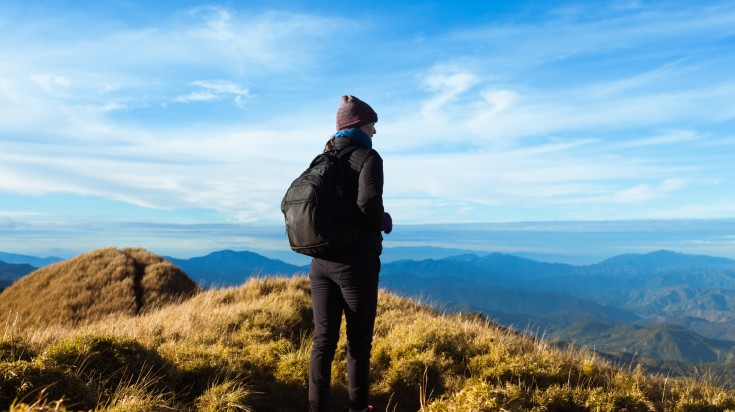 A hiker on then mountain top at Mount Pulag in the Philippines.