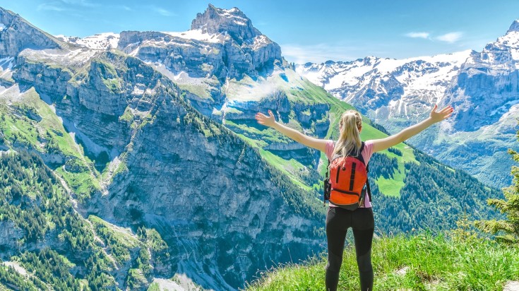 Stretch your arms and enjoy hiking to mountain tops in Switzerland.