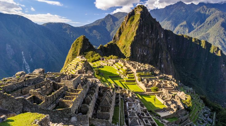 A wide angle aerial view of Machu Pichhu during the day in Peru. 