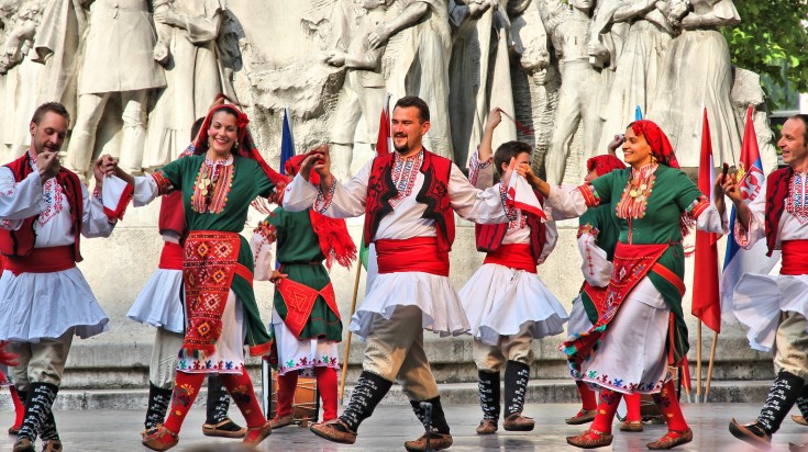 Local people in traditional wear dancing in Hungary in July.