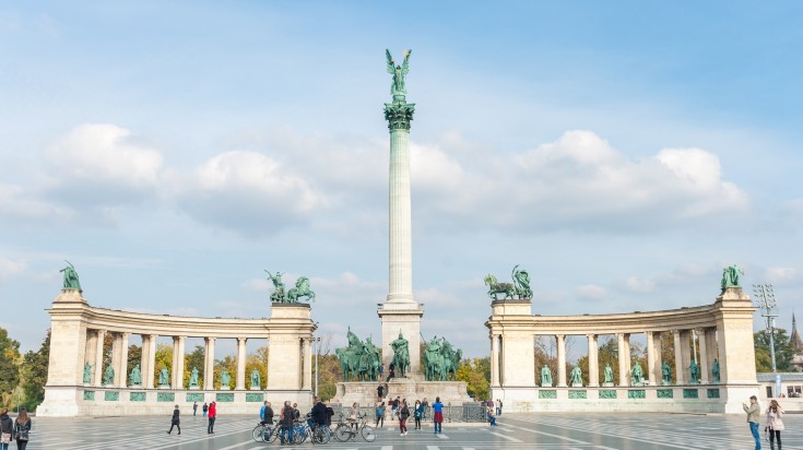 Heroes Square in Budapest with people walking and cycling around. Heroes Square in Budapest with people walking and cycling around.