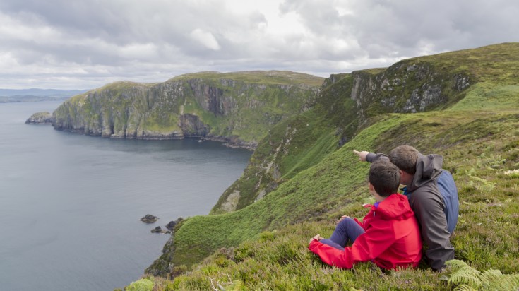 Father and son admires beauty landscape. Location Horn Head in Ireland co.