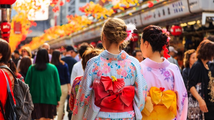 Tourists wear kimono while sightseeing on Japan group tours.