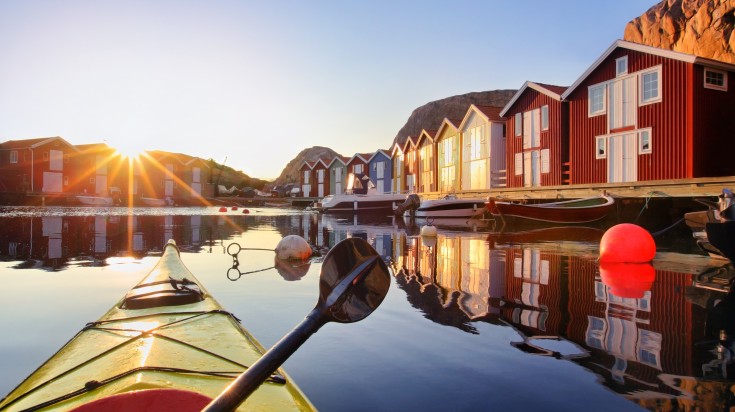 Kayaking boat as seen near the fishing huts of Smögen village in Sweden. Kayak as seen near the fishing huts of Smögen village in Sweden.