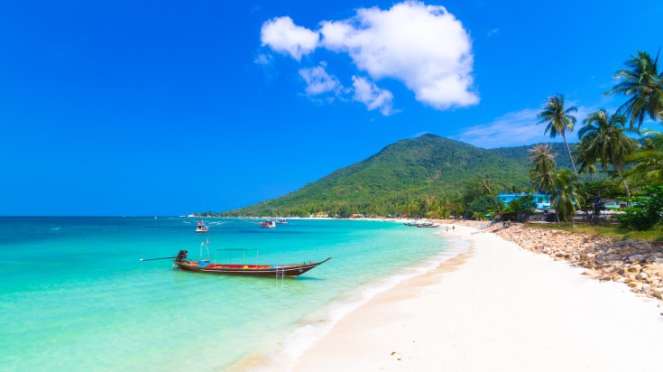 A wooden boat on a pleasant weather in Ko Pha Ngan beach in July.