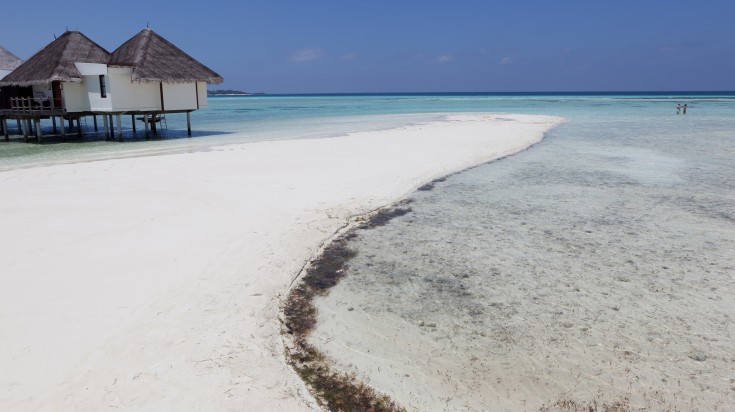 A couple walking on the shore on Kura Huraa in November.