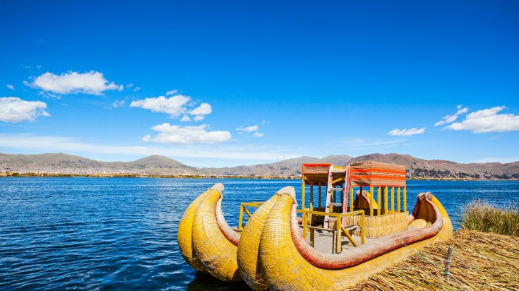 Totora boat on the Titicaca lake near Puno on a clear day in Peru.