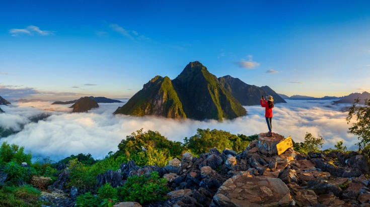 Go hiking above the clouds at Pha Dang in Laos while spending 2 weeks in Southeast Asia.
