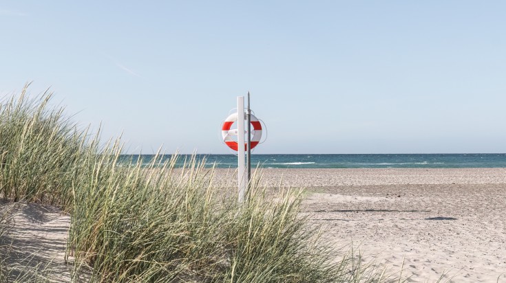 Life preserver in the North Sea's sandy beach.