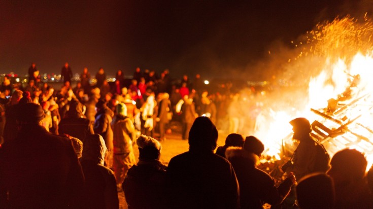 Locals celebrating New Year's Eve with a bonfire in Reykjavik.