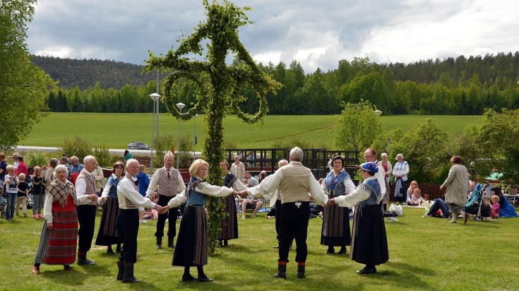 Locals of Denmark partaking in Maypole dancing.