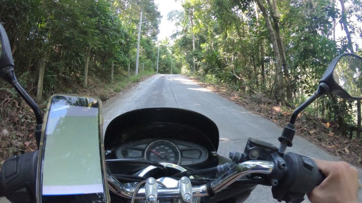 Man riding a motorike from Hanoi to Ho Chi Minh City guided by phone GPS.