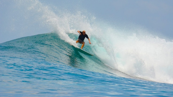 Man surfing in the Thulusdhoo Island.