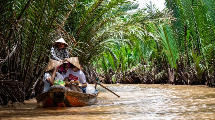 Tourists enjoying a boat ride in Mekong Delta.