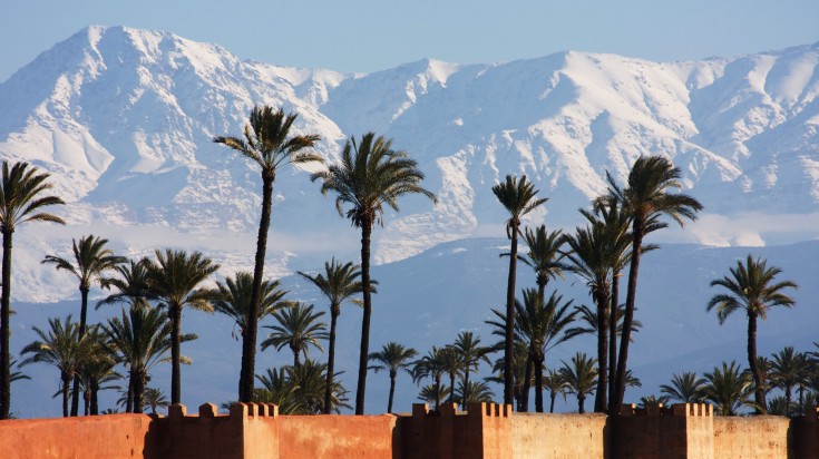 Marrakech in winter with snowy mountains in the distance.