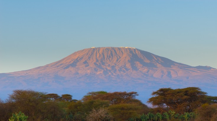 A view of Mount Kilimanjaro behind fog on a trip to Kenya and Tanzania.