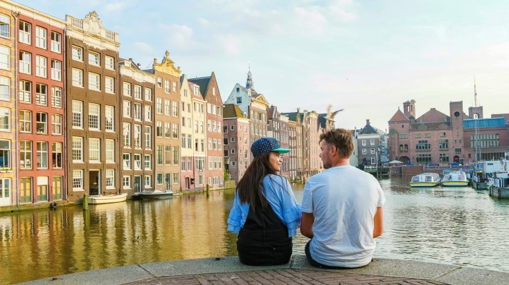 A couple looking at each other at a canal in Amsterdam in February.