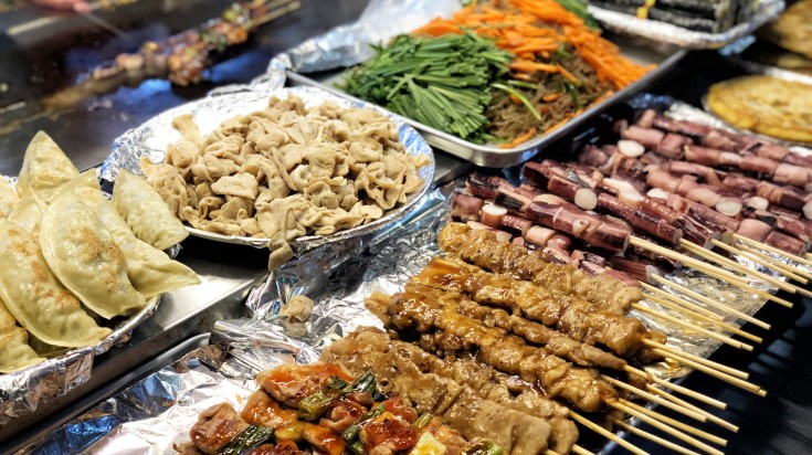 Street food displayed in the table at Don at night in Seoul in South Korea.