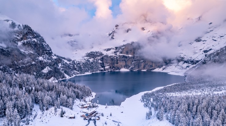 Oeschinen Lake glows like a mirror reflecting the snowy surrounding peaks