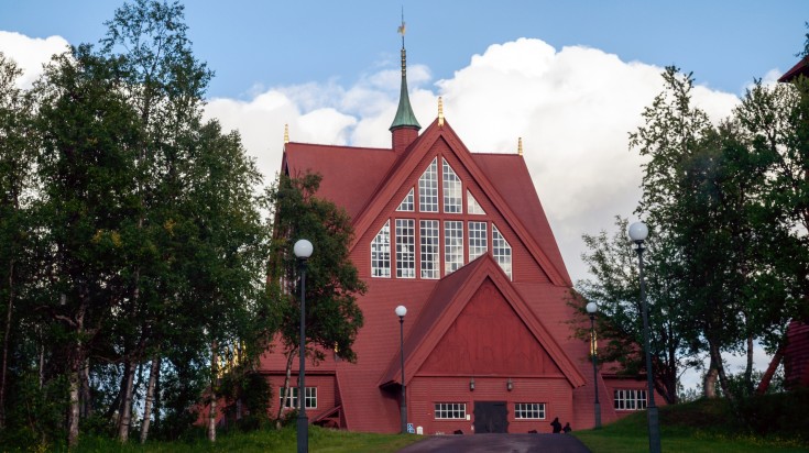 Wooden Red church in Kiruna against a clear blue sky in Sweden in November.