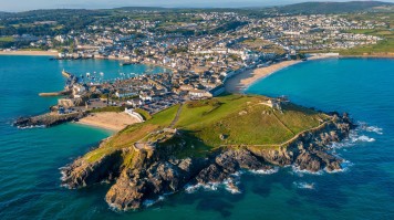 St. Ives is a beach destination that is also popular for surfing. An aerial view of St. Ives in Cornwall on a sunny day.