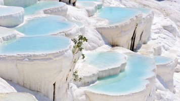 The thermal water flowing down the travertine terraces in Pamukkale is quite a sight to behold. Pamukkale is a town in western Turkey known for its thermal waters.