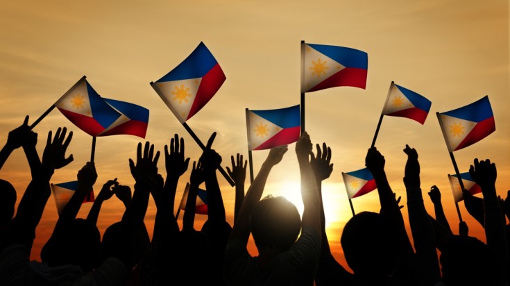 People Waving Filipino Flags for Independence day in Philippines in June.