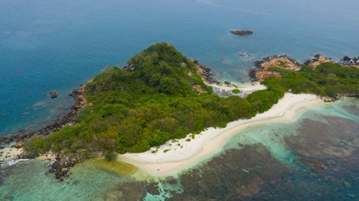 Aerial view of Pigeon Island with white sand and crystal clear water bay.