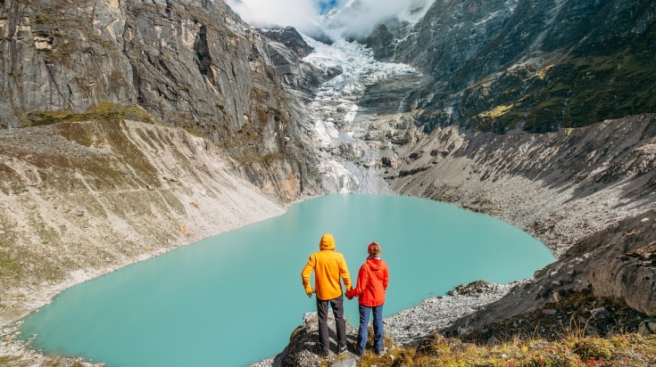 Two trekkers at Makalu Barun National Park enjoying the view of a glacier. Two trekkers at Makalu Barun National Park enjoying the view of a glacier.