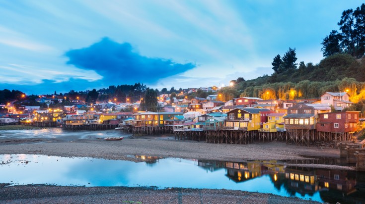 Chiloe's houses illuminated during sunset.