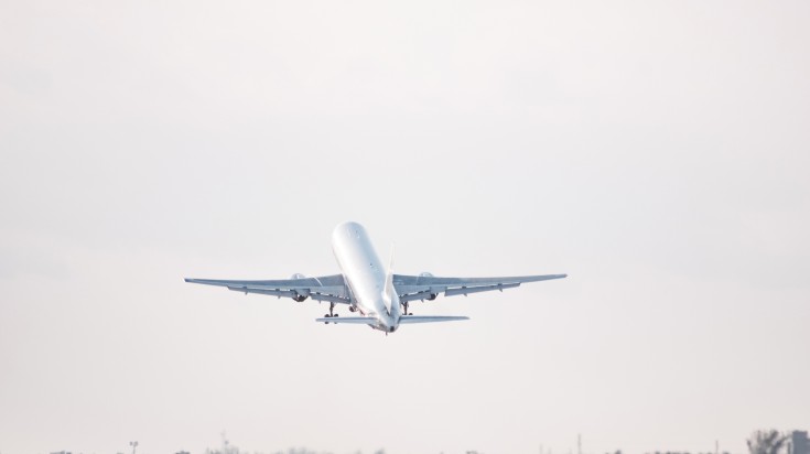 An airplane taking off from the runway of Santiago.