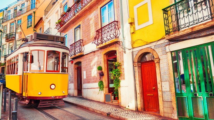 Yellow vintage tram on the street in Lisbon, Portugal