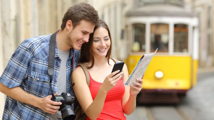 Couple of tourists consulting guide online