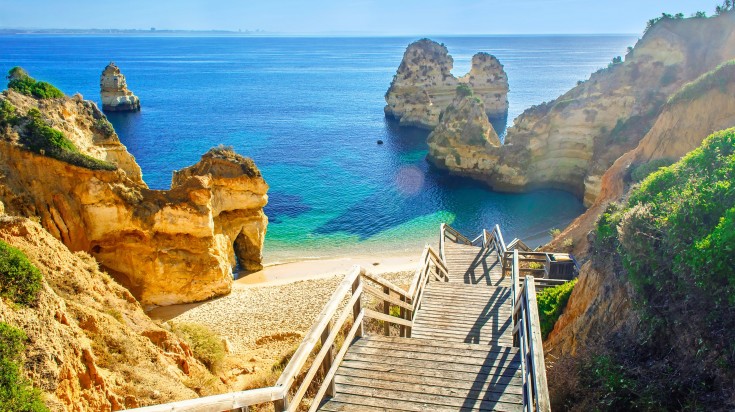 Wooden footbridge to beautiful beach Praia do Camilo near Lagos in algarve