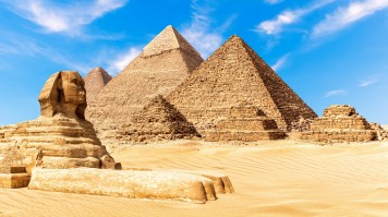 The Sphinx by the Pyramids of Giza in the desert of Egypt during a clear day. The Sphinx by the Pyramids of Giza in the desert of Egypt during a clear da