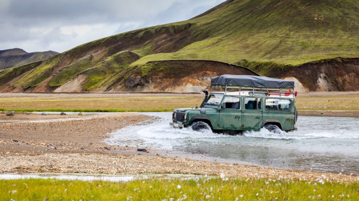 A 4x4 jeep crossing a river enroute Thorsmork.