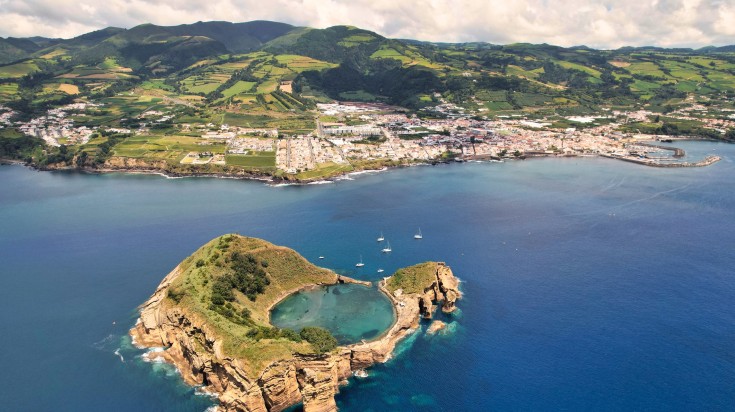 Aerial view of a tiny island in the middle of the sea