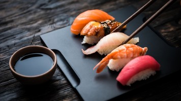 Raw fish or meat are sliced into bite-sized bits and eaten with soy sauce. Sashimi consists of raw fish or meat that is sliced into thin pieces.