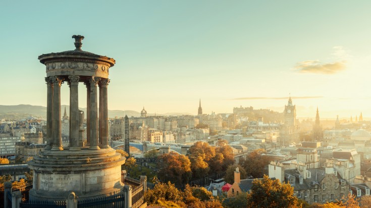 A view of Edinburgh city skyline from Calton Hill at sunrise.