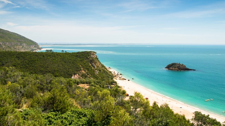 Beautiful landscape with golden beach and green hill on a clear day in Arrá