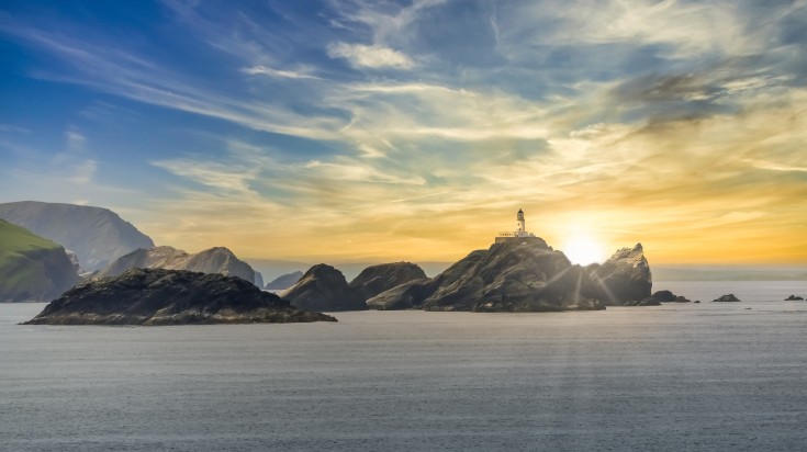 View of Shetland Islands with its lighthouse at sunset.