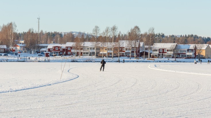 People skating on a frozen lake in Sweden during January.