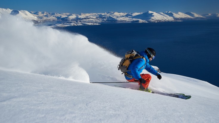 A man skiing in the snow mountain during winter in Norway.