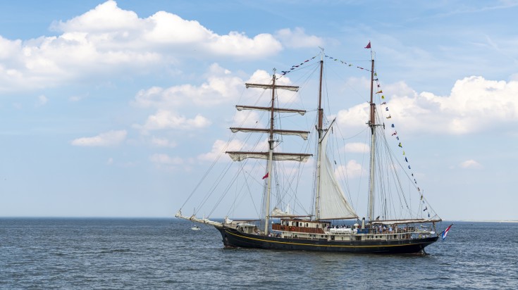 An antique tall ship leaving the harbor in the Netherlands in August.