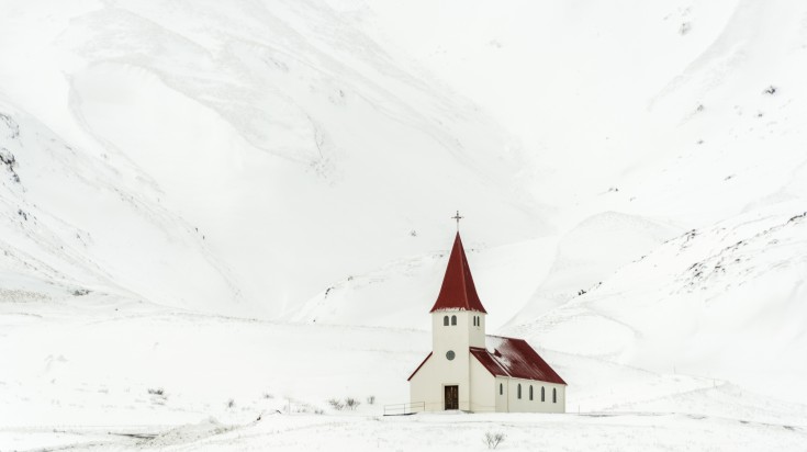 Snow-covered surrounding of Vik Church in December.